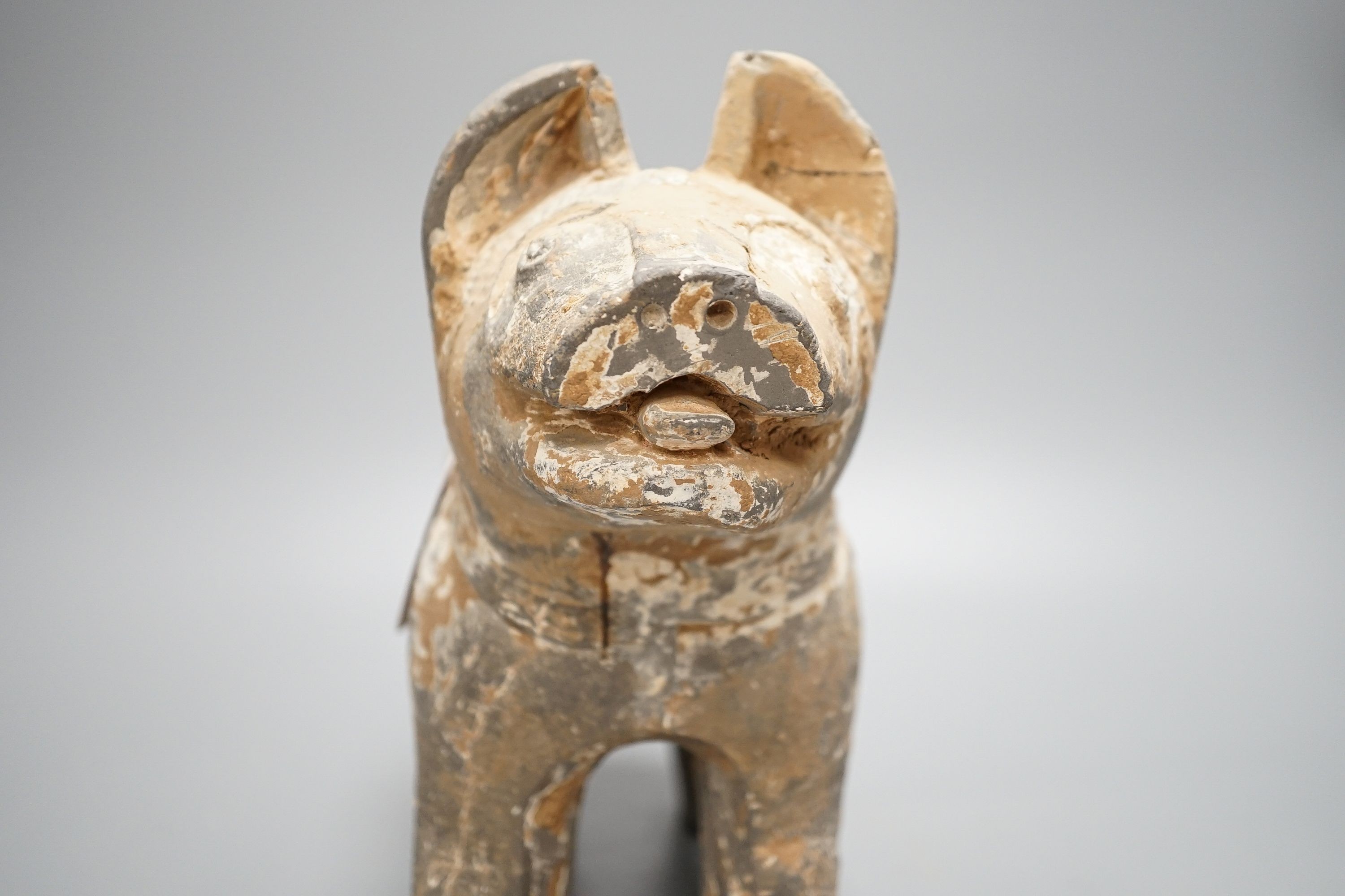 A Chinese painted grey pottery figure of a dog, probably Han dynasty, length 32cm, with 1991 invoice